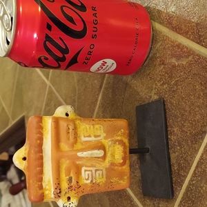 Small terra cotta tribal mask on stand